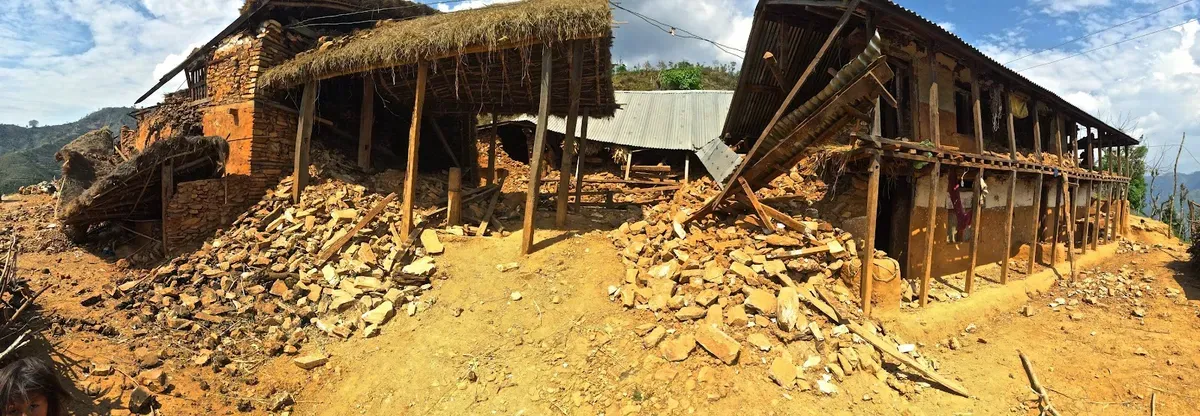 Panorama of earthquake-damaged houses and fallen masonry
