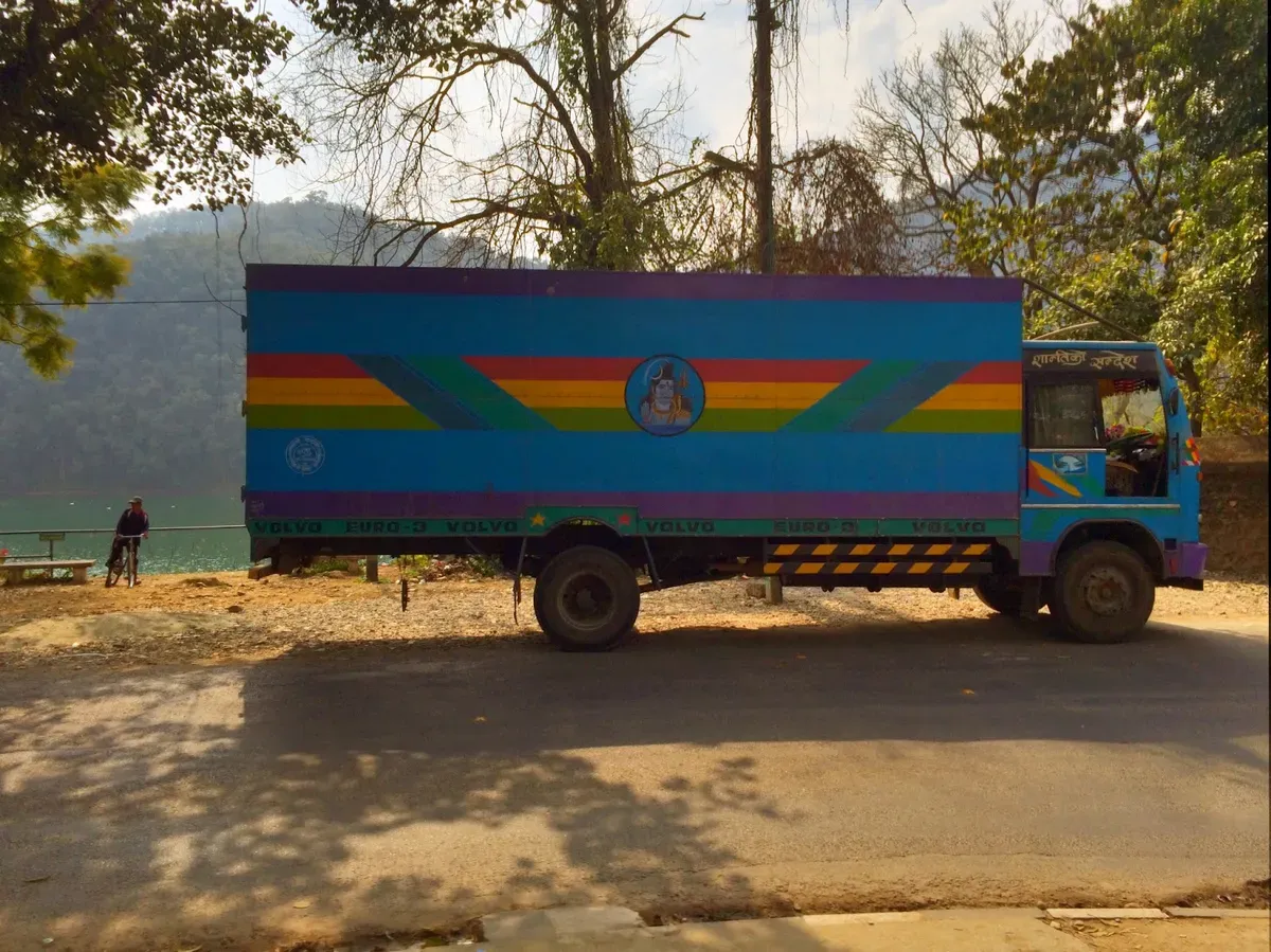 Colourfully painted truck beside a road in Pokhara