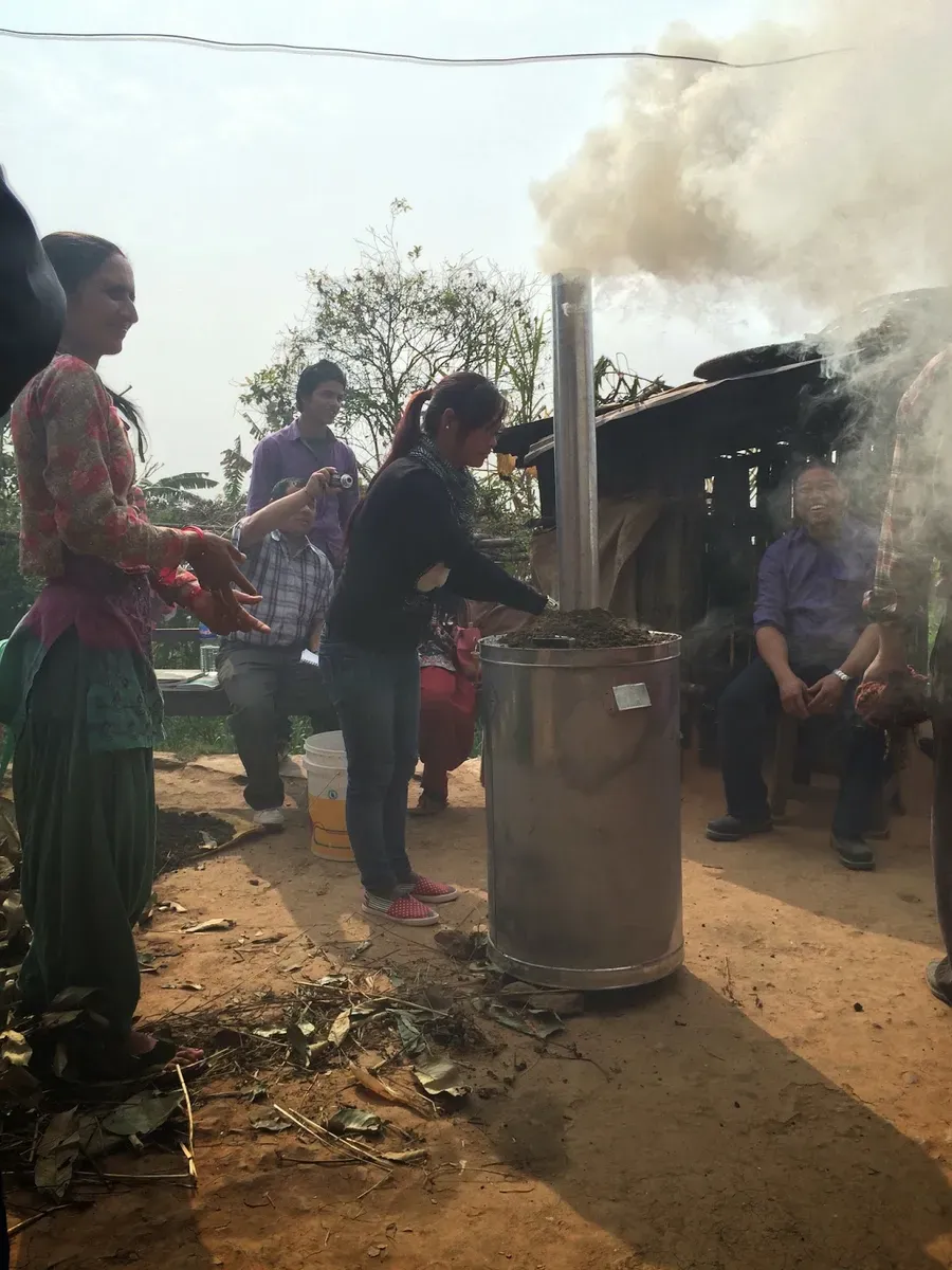 Smoke rising from the drum as the group watches