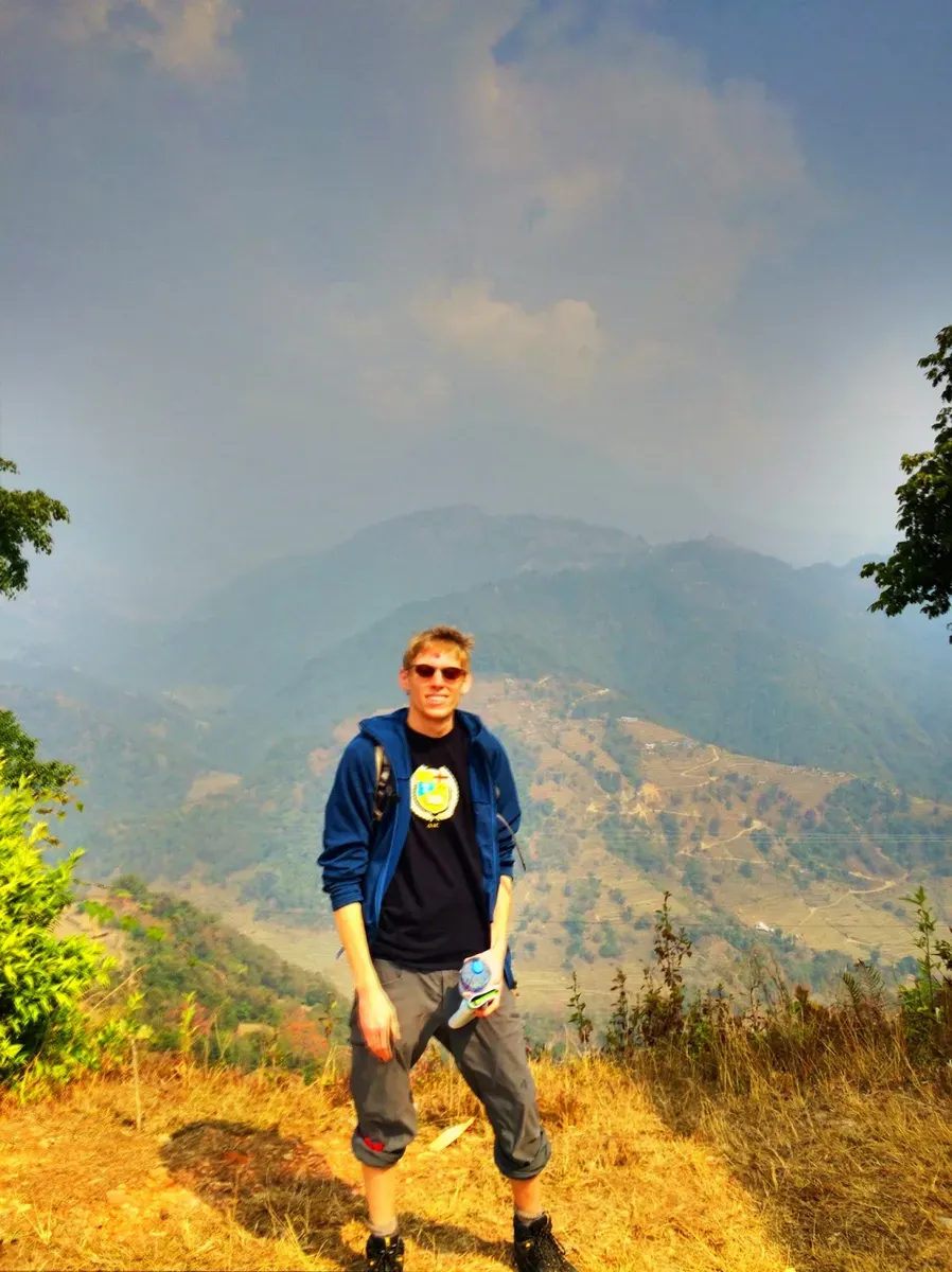A hiker standing above a mountain valley