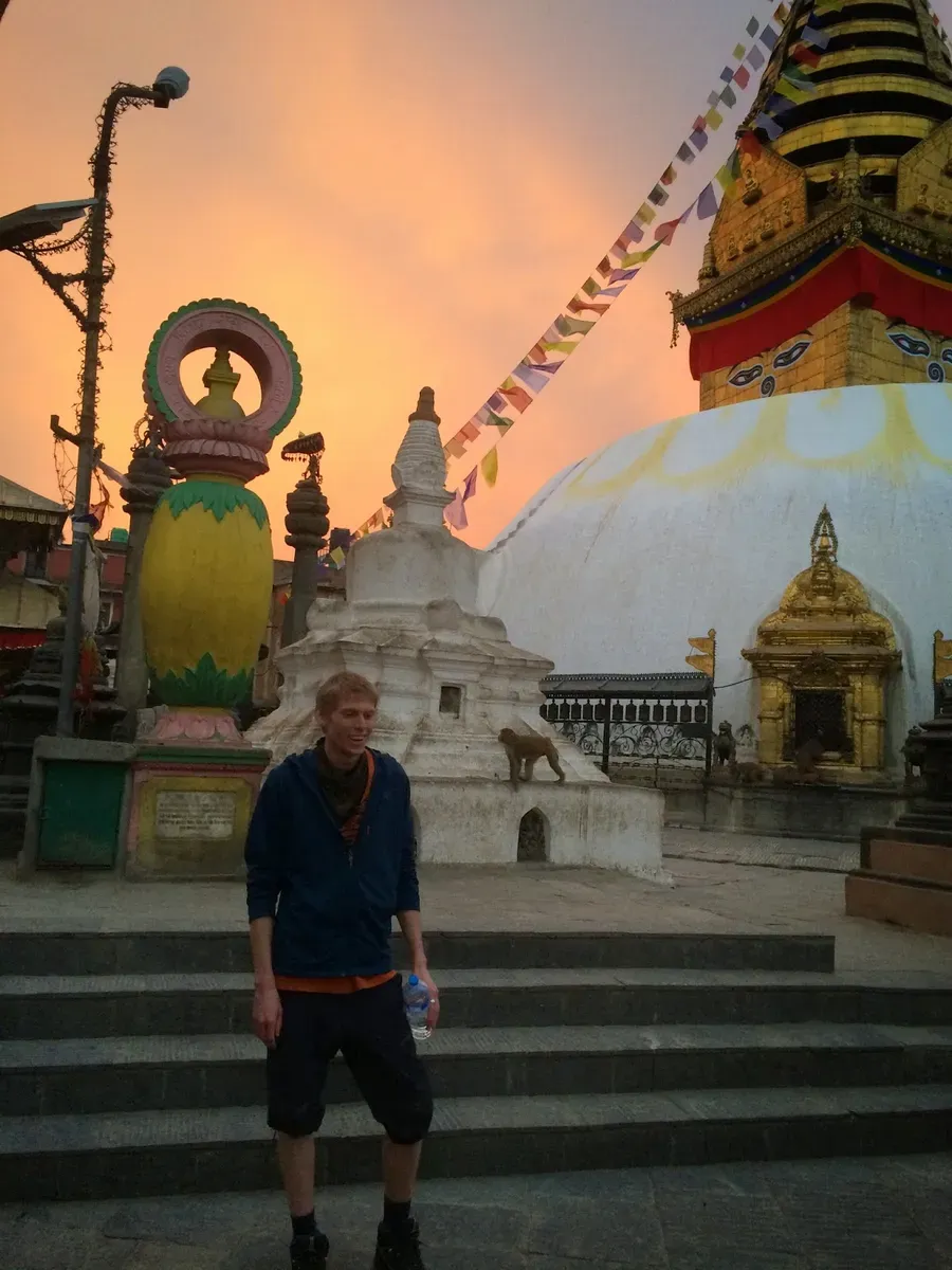 A traveller on the steps beside the golden stupa